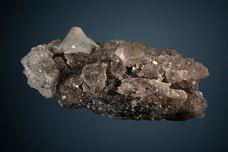 PHENAKITE with HEMATITE on QUARTZ