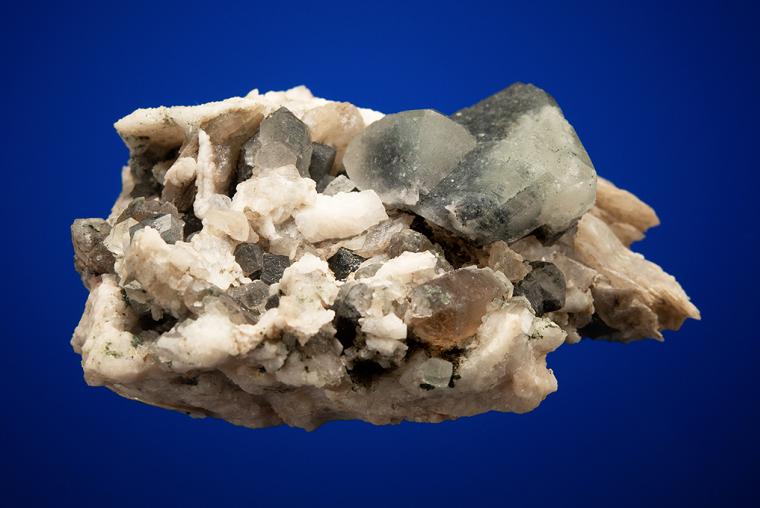 PHENAKITE on QUARTZ var. Smoky and CALCITE