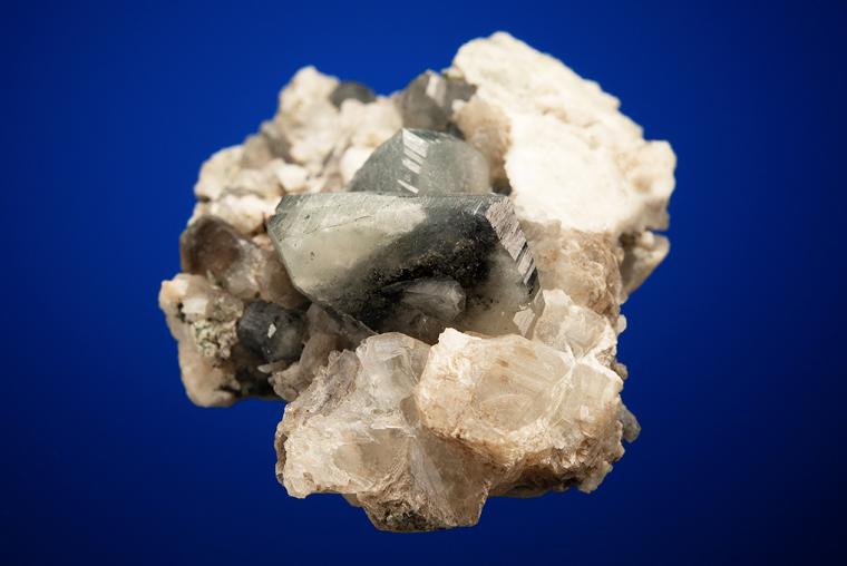 PHENAKITE on QUARTZ var. Smoky and CALCITE